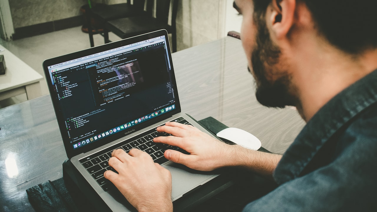 Small business owner managing website security and updates on a laptop