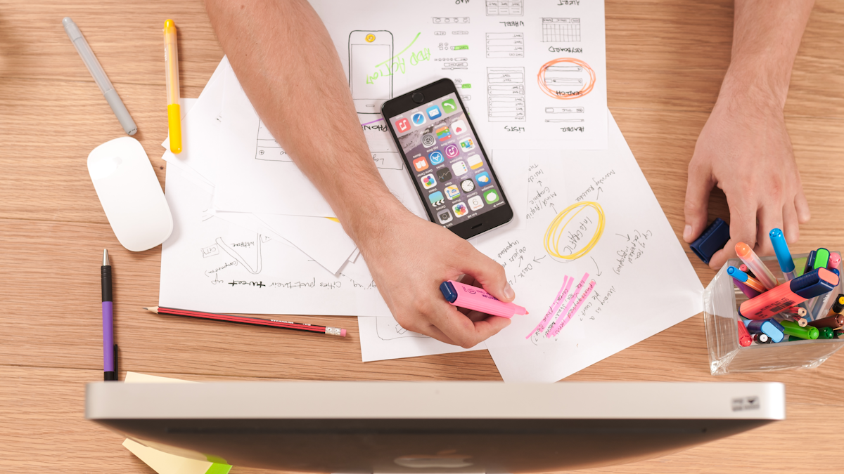 Person writing website copy at a desk with coffee